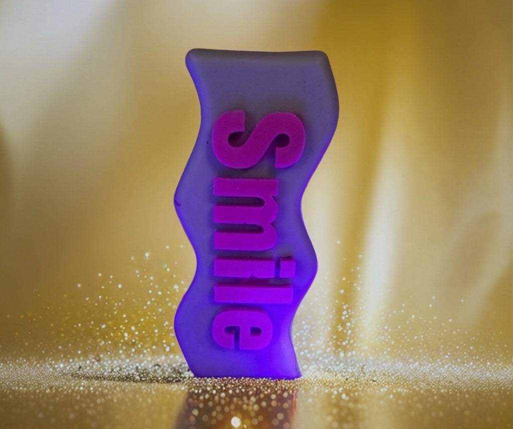 Purple Smile Candle with uplifting "Smile" message, hand-poured soy wax, available scented or unscented for cozy ambiance