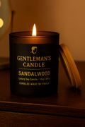 Sleek black jar sandalwood candle with rich masculine fragrance for relaxation and focus