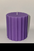 Ribbed cylinder pillar candle in purple, white, and yellow with soy wax and aromatherapy scents