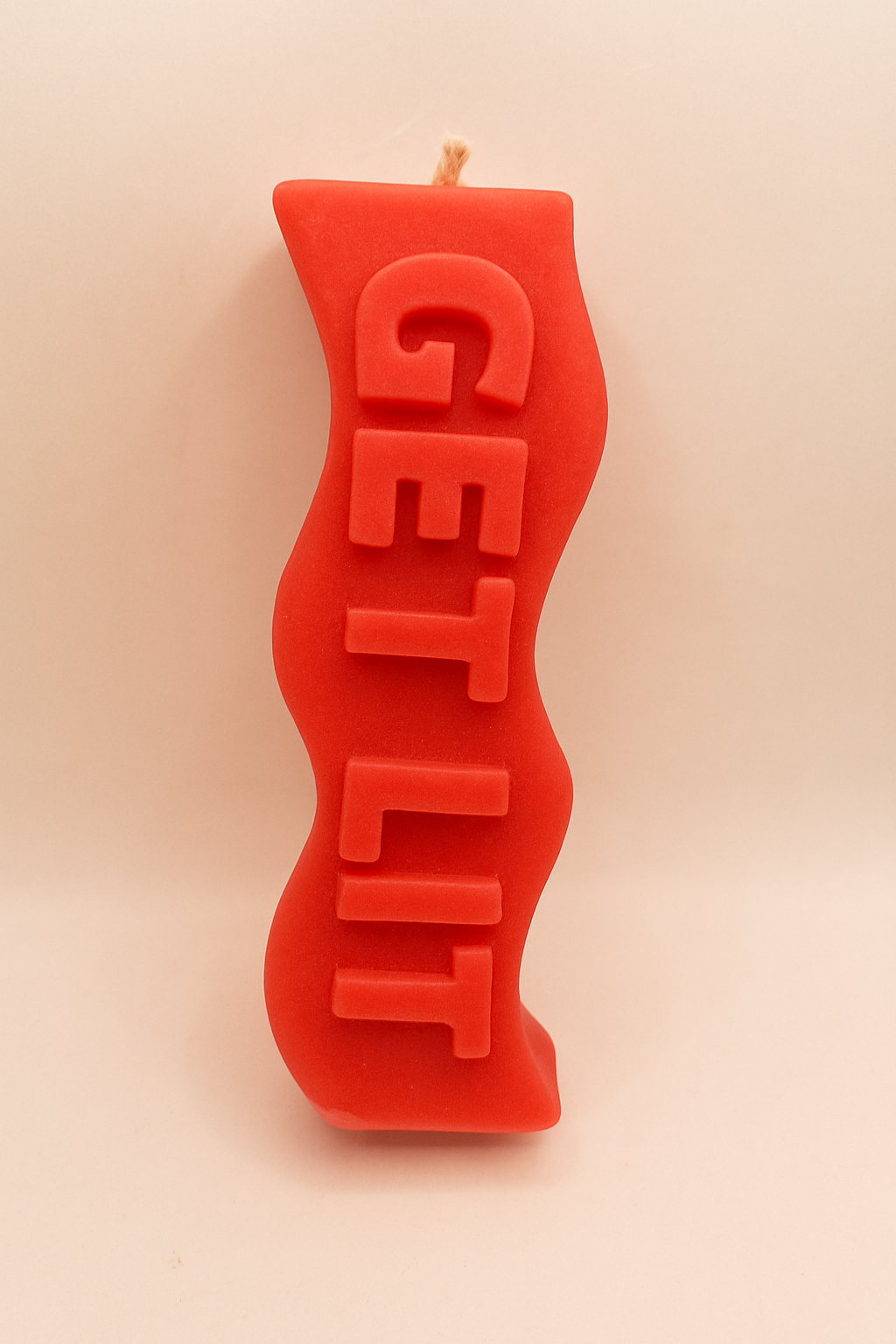 Red Get Lit Candle with playful slogan and warm cinnamon scent in vibrant red finish