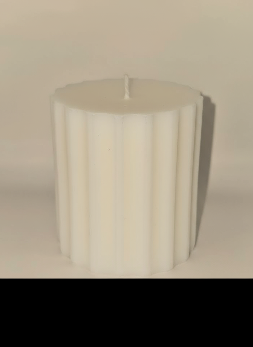 Ribbed cylinder pillar candle in purple, white, and yellow with premium soy wax and aromatherapy scents
